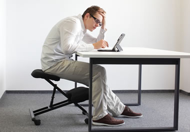 Man slouching over his computer