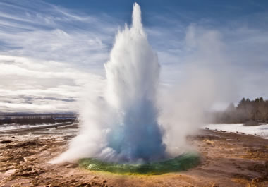 A geyser shooting out water and steam