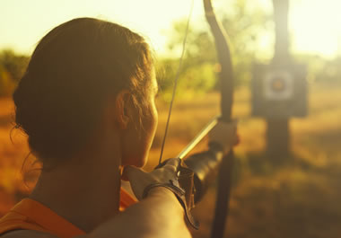 The woman is aiming right at the target.