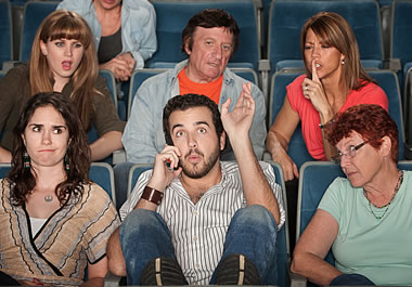 Talking on the phone during a movie is inappropriate.