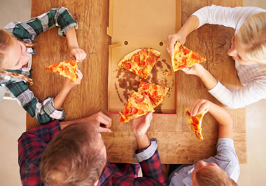 The hungry kids dove right into the pizza.