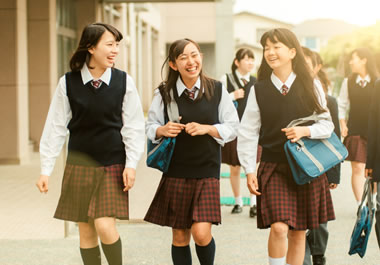 The girls are wearing a standard school uniform.