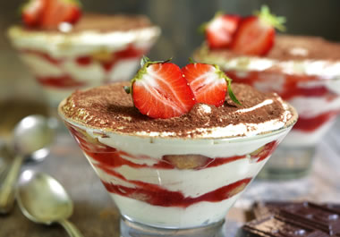 The dessert is made by alternating layers of cream and fruit.