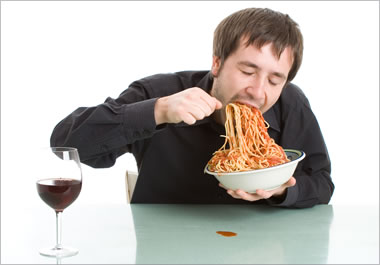 The man is scarfing down the pasta.