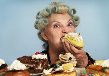 The woman is gorging on desserts.