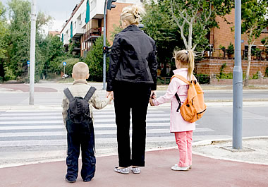 Mother accompanying her children on the way to school