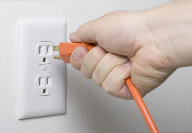 Plugging an electric cord in a wall socket