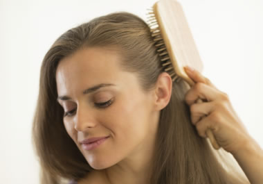 Woman using a hairbrush
