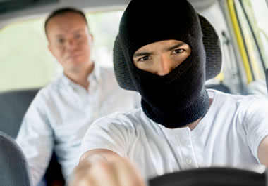 Man being kidnapped by a driver wearing a hood