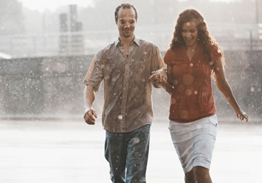 The couple is caught in a downpour.