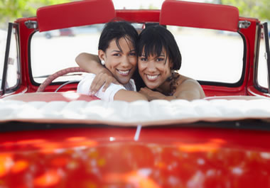 Two sisters in a red convertible