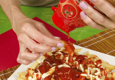 The woman is going heavy on the ketchup.