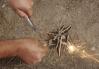 Starting a fire with twigs and sparks