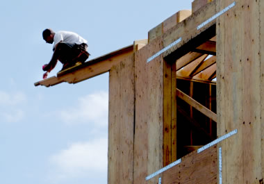 A construction worker in a precarious spot