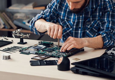 The man makes a living repairing computers.