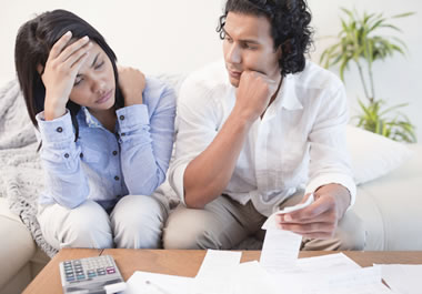 An anxious couple worried about their debt