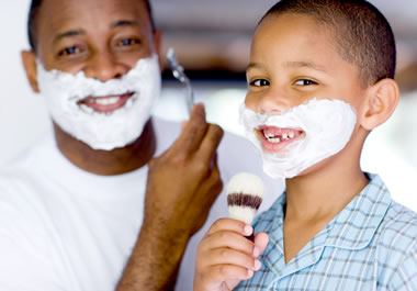 Boy imitating his father shaving