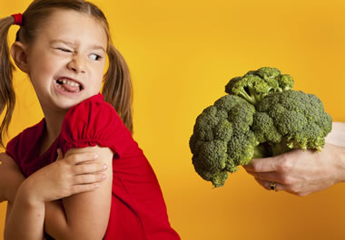 The girl obviously does not like broccoli.