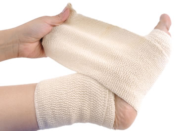 Wrapping a sprained ankle will help prevent it from swelling.