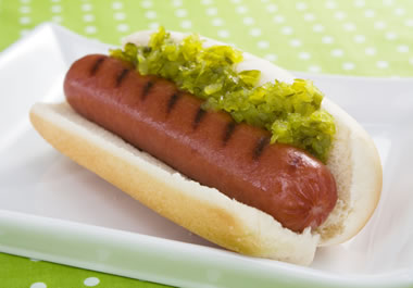A hot dog with relish on top