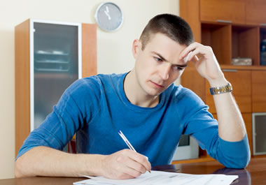 A man completing the paperwork for an application