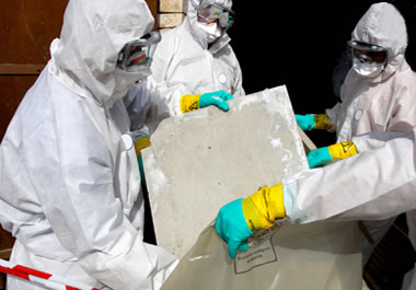 A team of specialists removing asbestos, a known carcinogen