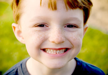 A young boy with freckles on his face