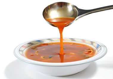Ladling soup into a bowl
