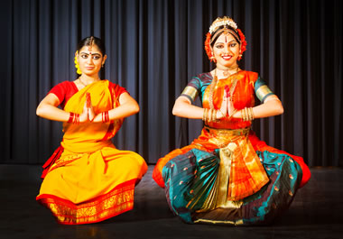 The women are attired in colorful dresses.