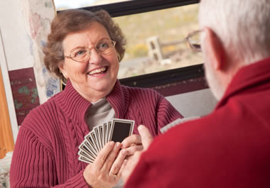 A couple playing a lighthearted game of cards.