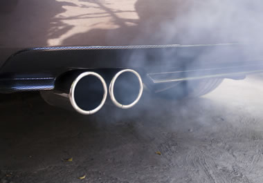 Exhaust emissions from the back of an old car