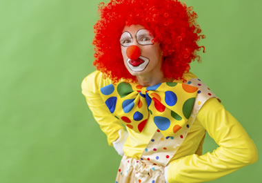 A clown with arms akimbo