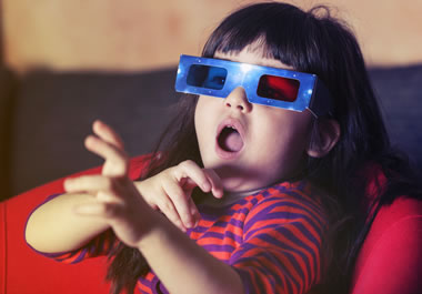 The girl marvels at the 3-D movie.