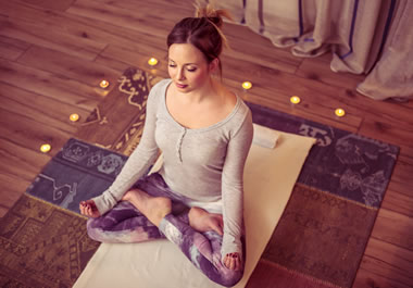 The woman is meditating to recharge.