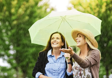 The women had the foresight to bring an umbrella.