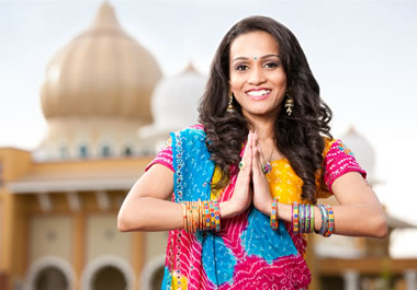 The woman is wearing a variety of bangles on her arms.