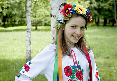 Flowers are embroidered on the girl's shirt.