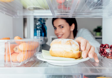 The woman finds the doughnut to be irresistible.