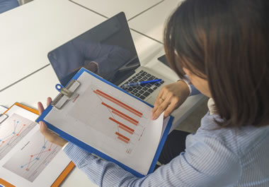 The woman is compiling information for a report.