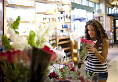 A woman smelling a redolent bouquet