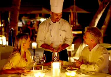 The couple is enjoying a meal at a swanky restaurant.