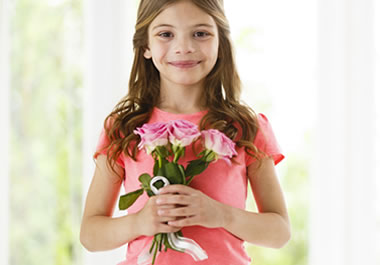 A young girl holding a nosegay