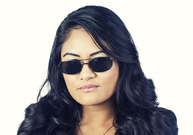 The sunglasses conceal her eyes.