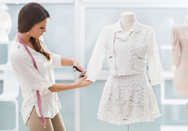 The woman is tailoring the jacket.