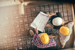 construction workers consulting blueprint