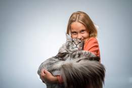 girl holding extremely fluffy cat