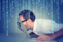 man leaning into computer