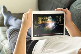 man-lying-with-tablet