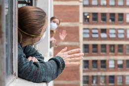 neighbors waving to each other from windows