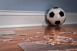 soccer ball next to broken glass